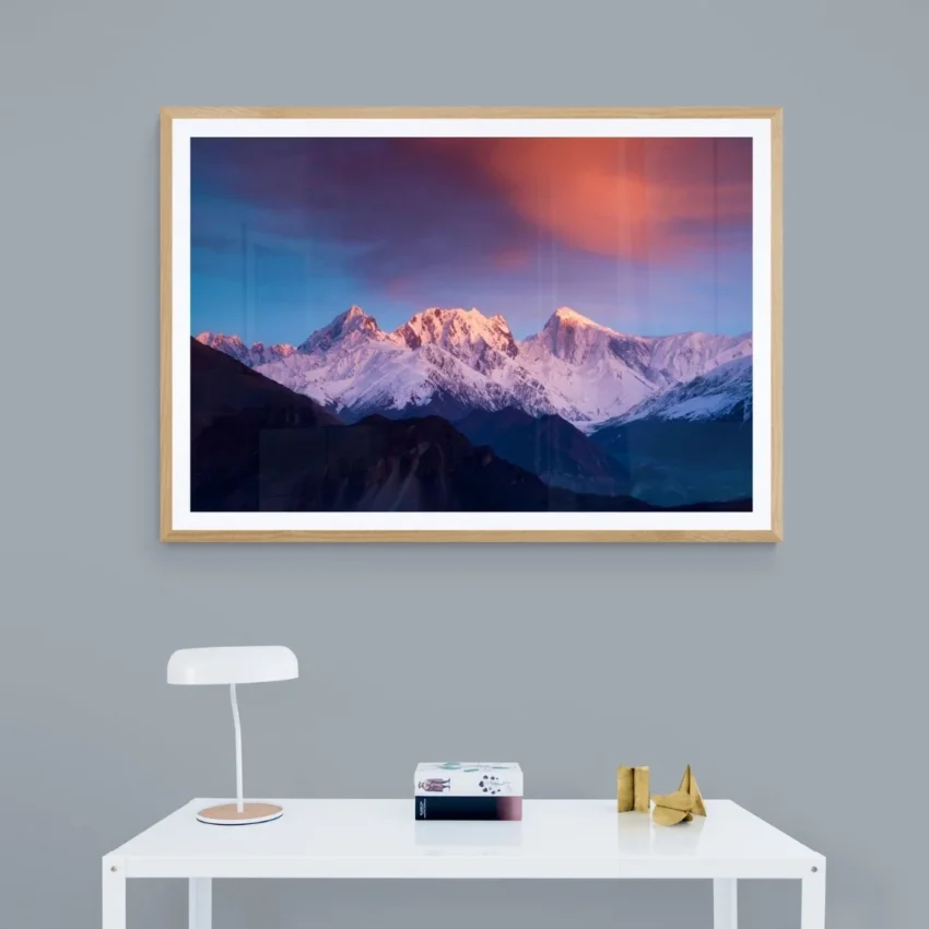 Nature-themed canvas wall art of majestic mountains with snowy peaks, reflecting a serene sunrise against a dramatic pink and blue sky.