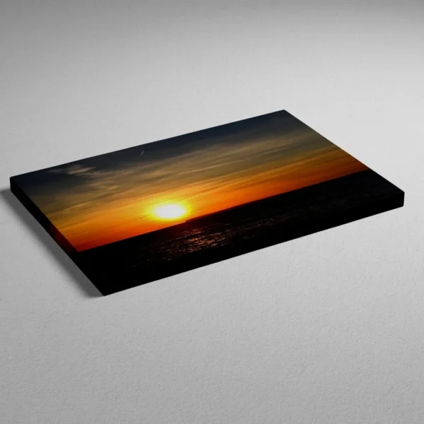 Nature-themed canvas wall art of a painting titled "Golden Serenity" capturing a timeless sunset over the ocean.