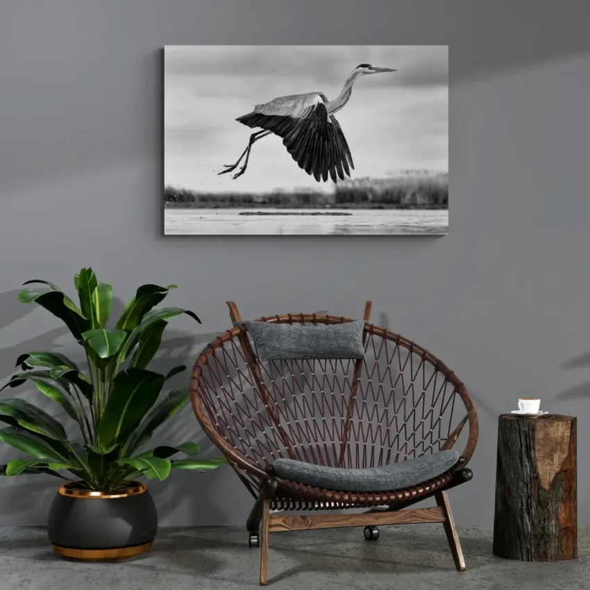 Nature-themed canvas wall art showing a heron with its wings spread in mid-flight over water.