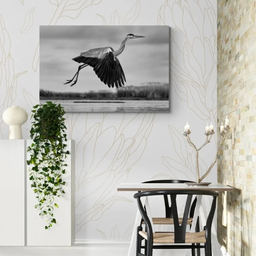 Nature-themed canvas wall art showing a heron with its wings spread in mid-flight over water.
