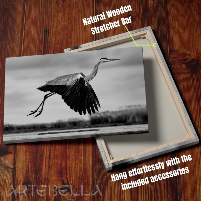 Nature-themed canvas wall art showing a heron with its wings spread in mid-flight over water.