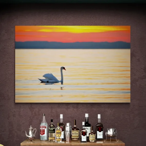 Nature-themed gallery wraps canvas wall art of a serene white swan gliding on calm water during a vibrant orange and gold sunset capturing a peaceful and elegant atmosphere.