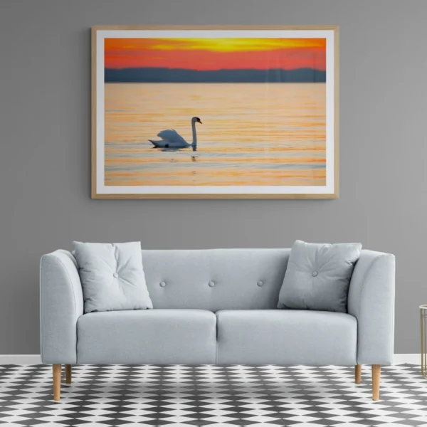 Nature-themed gallery wraps canvas wall art of a serene white swan gliding on calm water during a vibrant orange and gold sunset capturing a peaceful and elegant atmosphere.
