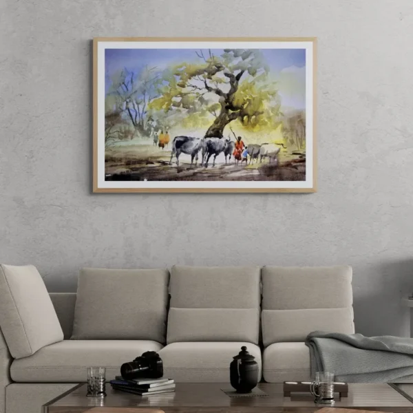 A framed painting titled "Rural Serenity" showing cattle and villagers resting under a large banyan tree in a peaceful countryside scene.