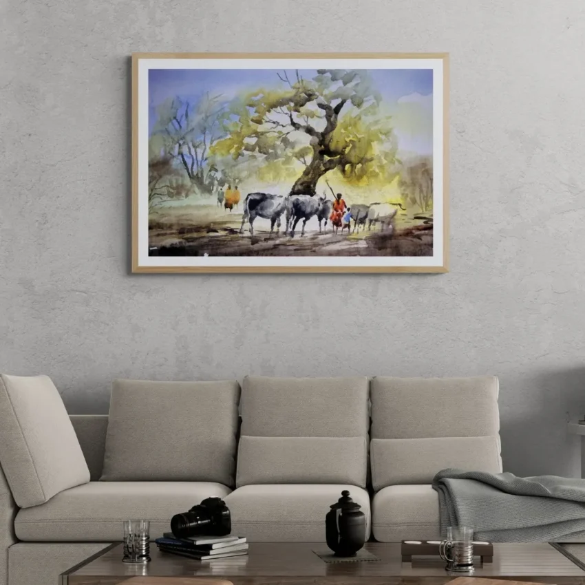 A framed painting titled "Rural Serenity" showing cattle and villagers resting under a large banyan tree in a peaceful countryside scene.