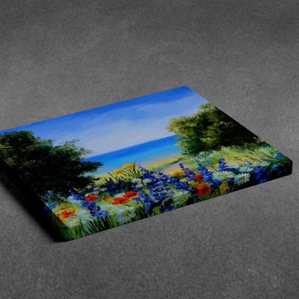 A vibrant painting titled "Tranquil-seascape-with-wild-flowers " showing a field of wildflowers with a path leading to a blue ocean and beach, displayed as nature wall art.